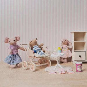 cozy caring moment as characters learn to care for a baby in a gentle dollhouse nursery scene.