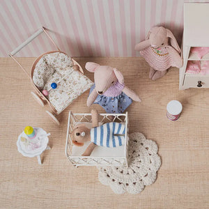 top view of dollhouse nursery layout showing crib stroller table and baby accessories arranged in a detailed 1:12 scene.