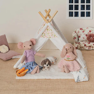 Bunny and mouse figures sitting inside a small indoor tent with puppy and cushions in a soft 1:12 miniature living room scene.