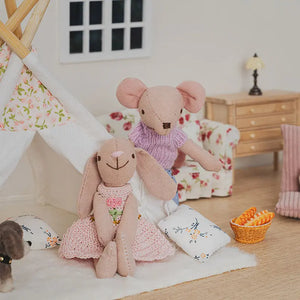 Bunny and mouse figures sitting inside a small indoor tent with puppy and cushions in a soft 1:12 miniature living room scene.