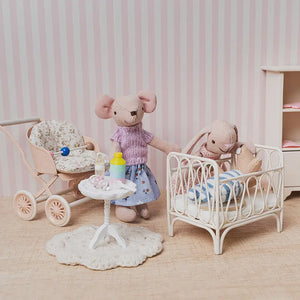 gentle dollhouse moment where characters learn to care for a baby, creating a warm and nurturing nursery scene.