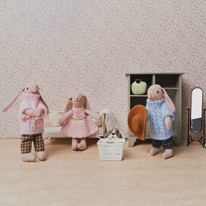 Miniature bunny family organizing outfits and accessories in a warm 1:12 dollhouse dressing room storytelling scene