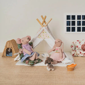 Close-up of bunny and mouse figures relaxing with cushions and cozy decor in a gentle miniature home environment.