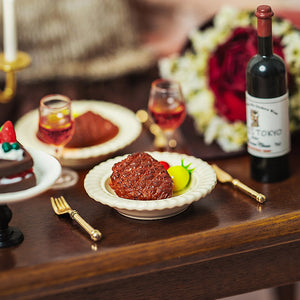 Dollhouse dining scene showing a handcrafted clay steak set arranged on a table in a 1:12 scale setting