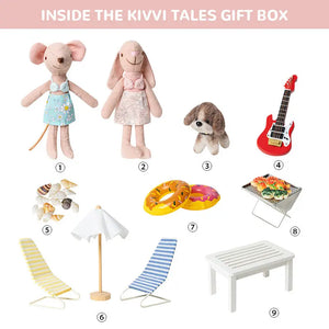 Inside the Kivvi Tales gift box: dollhouse scale beach set including figurines and props.