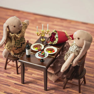 Dollhouse scene showing a resin candle with metal mini candle holder placed on a table in a 1:12 scale miniature setting
