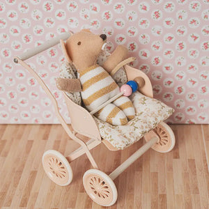 Miniature mouse baby in yellow romper, placed in a 1:12 scale stroller with soft floral bedding for cozy dollhouse scenes.