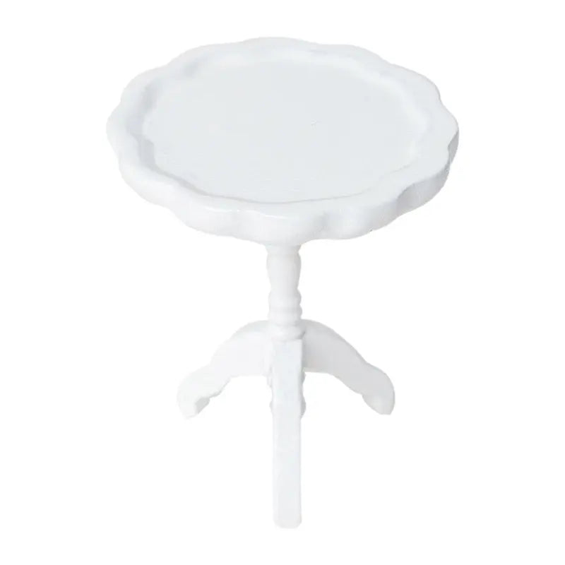 White miniature side table with scalloped wood top and curved pedestal legs for a soft dollhouse interior