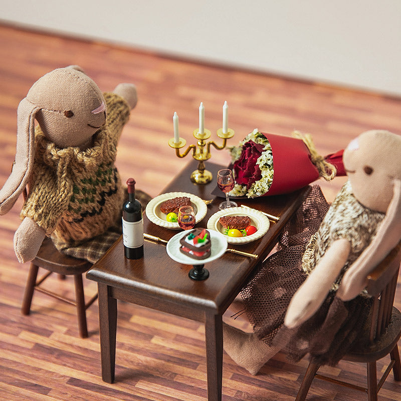 Dollhouse scene showing a resin candle with metal mini candle holder placed on a table in a 1:12 scale miniature setting