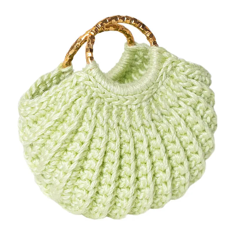 Light green dollhouse handbag with hand-crocheted texture and gold handles, a sweet accent for tiny outfits