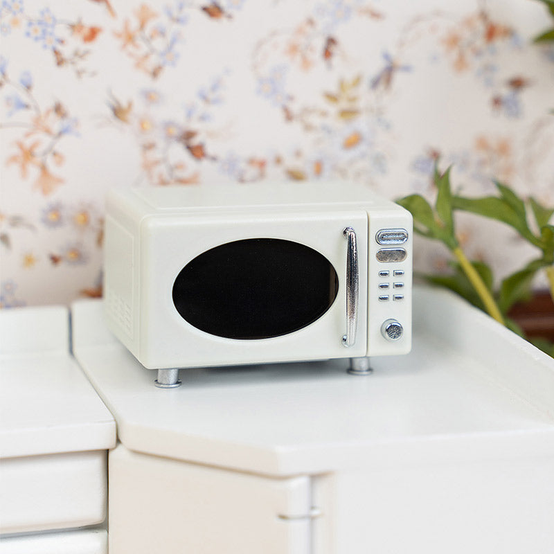 Miniature microwave oven styled on kitchen counter, warm dollhouse appliance decor for pantry shelves or breakfast nook scenes