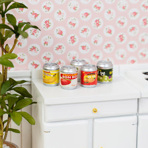 Colorful miniature drink cans styled on dollhouse countertop, cheerful soda decor for kitchen snack corner with cozy everyday realism