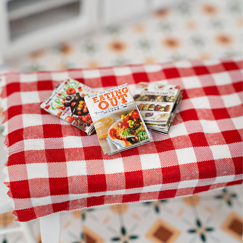 Miniature kitchen decor magazines on gingham table, warm 1:12 scale dollhouse cafe styling with colorful flippable pages