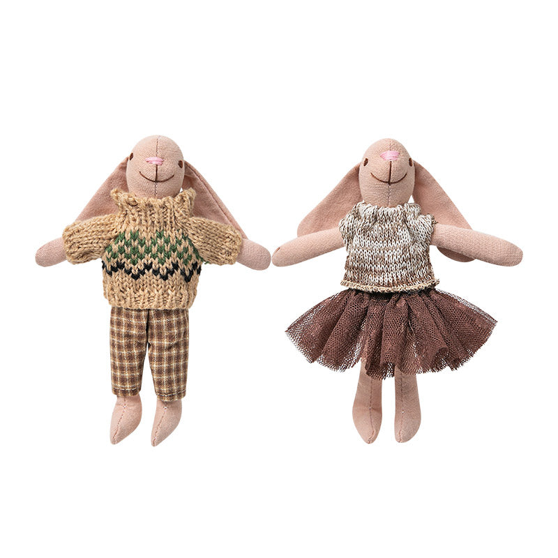 White background image of a fabric bunny couple wearing outfits, designed as figures for a 1:12 scale dollhouse