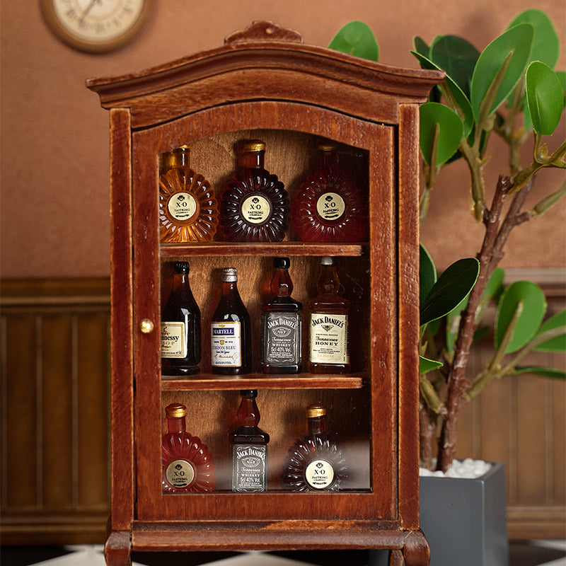 Vintage walnut liquor cabinet close-up with miniature bottles, warm dollhouse dining room accent beside plants, cozy handcrafted 1:12 scene
