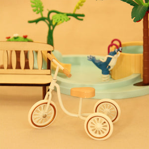 Miniature playground decor yellow retro tricycle beside pool scene, nostalgic 1:12 scale dollhouse summer styling