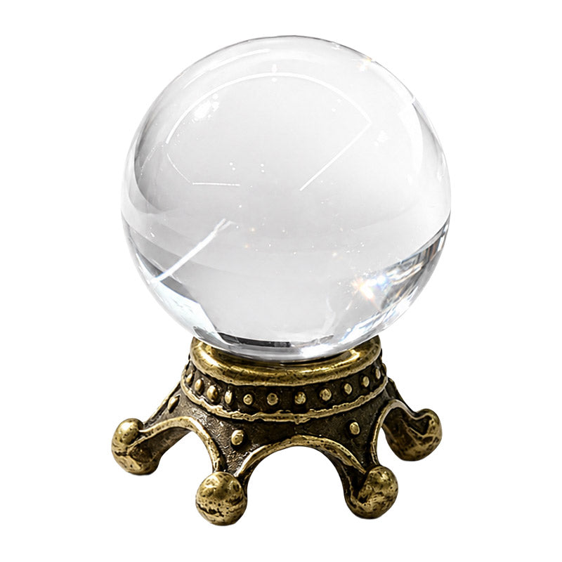 Miniature crystal ball with clear glass orb and antique brass stand for a magic library or fortune-teller scene.