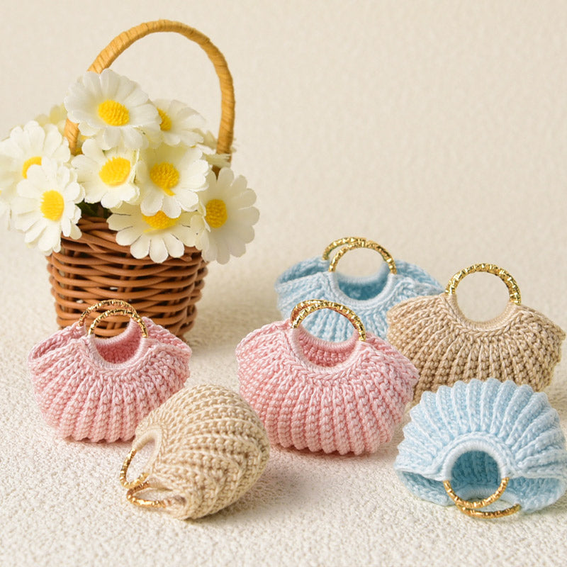 Crocheted miniature handbags in four pastel colors with gold handles, ready for different tiny outfits and stories
