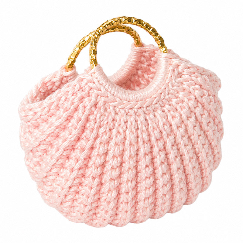 Pink dollhouse handbag hand-crocheted from yarn with gold handles, a charming match for miniature wardrobes