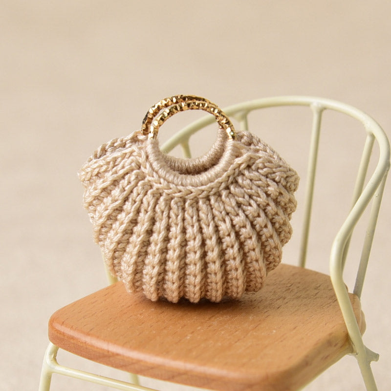 Beige crochet handbag styled on a tiny chair, adding warm texture and an everyday touch to a miniature room