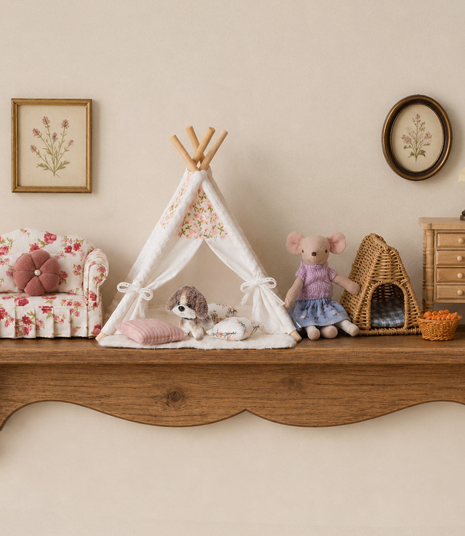 Cozy dollhouse living room with floral sofa, play tent, mouse friend and tiny pets in a warm cottage-inspired setting