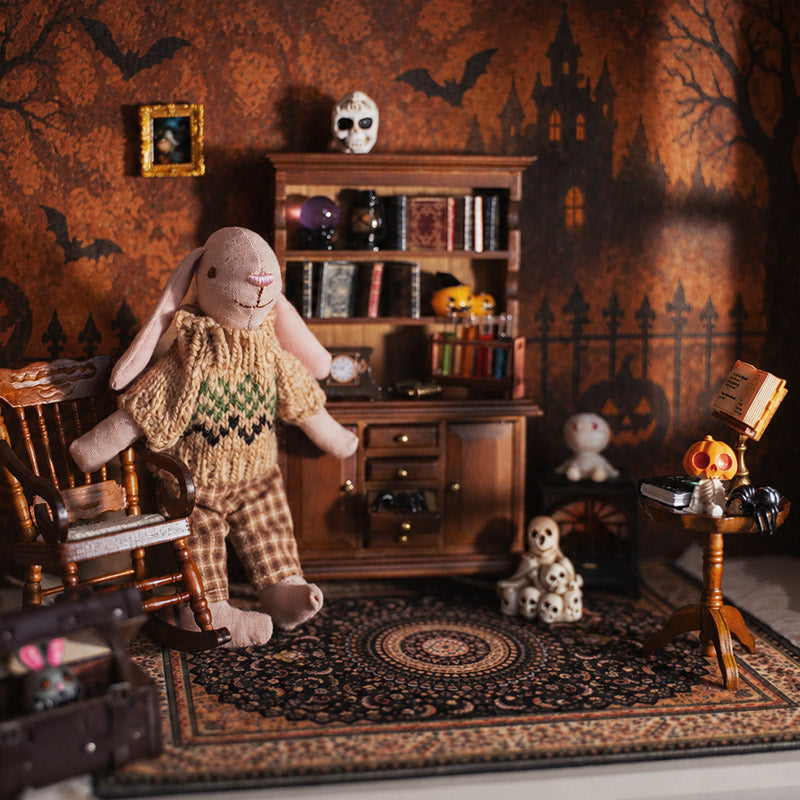 Warm 1:12 Halloween study with bunny figure, vintage bookcase, patterned rug and playful spooky decor