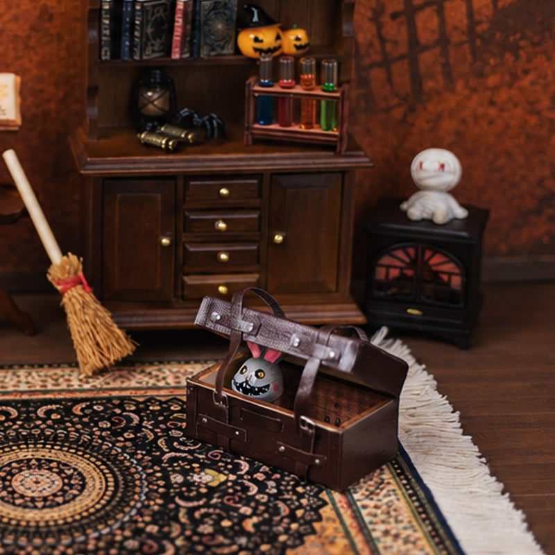 Tiny Halloween trunk scene with creepy bunny, broom, glowing fireplace and vintage rug in a witchy study