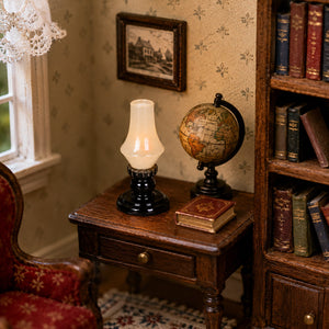 Classic miniature oil lamp on a wooden study table with books and globe, creating a warm old-fashioned reading corner.