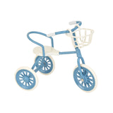 Blue dollhouse tricycle with basket, a cheerful miniature ride for garden paths and playful everyday adventures