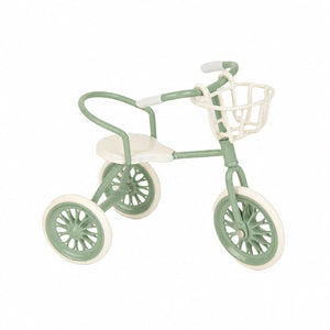 Green dollhouse tricycle with basket, a charming miniature accent for gardens, picnics and sunny outdoor stories