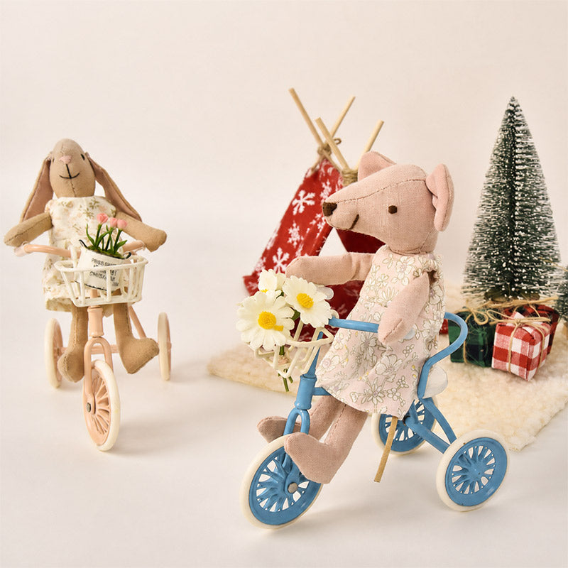 Miniature tricycles with flower-filled baskets bring two little friends together for a cheerful outdoor ride