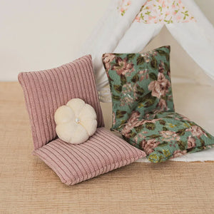 Vintage dollhouse floor sofa styled in a tiny room corner with soft pillows for relaxing moments