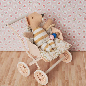 Miniature mouse baby in yellow romper, placed in a 1:12 scale stroller with soft floral bedding for cozy dollhouse scenes.