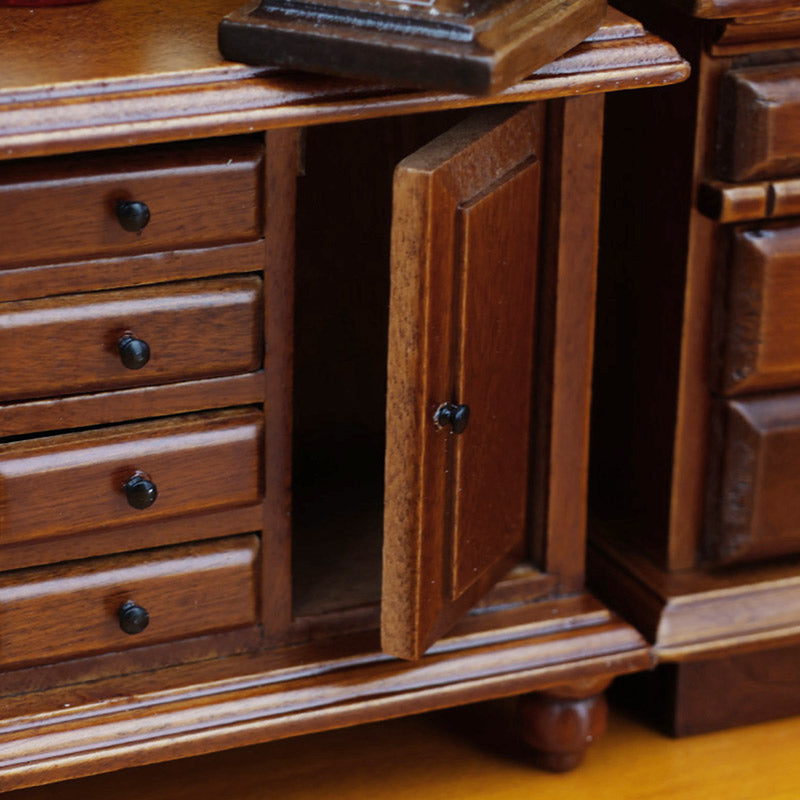 Miniature wooden storage cabinet with an open side door, adding functional detail to a classic room scene