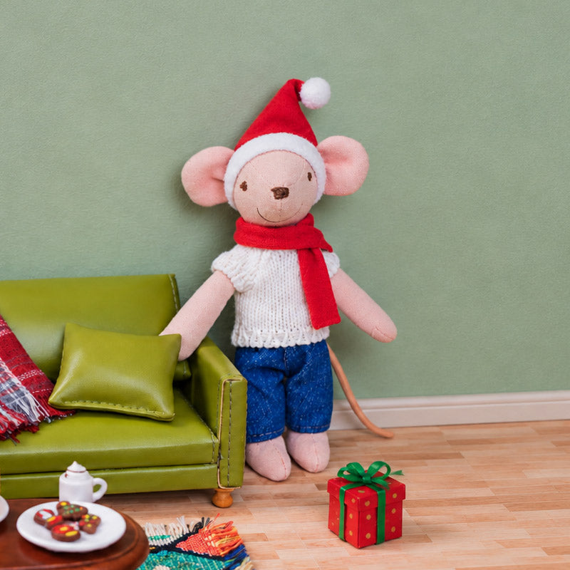 Handmade father mouse doll beside a green sofa and wrapped Christmas gift, bringing warmth to a cozy holiday living room.
