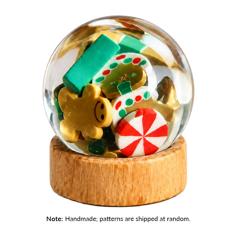 Miniature Christmas Snow Globe with colorful candy decorations and a wooden base, adding festive charm to holiday decor