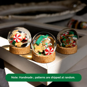 Handmade Christmas globe ornaments with assorted candy patterns, perfect for styling a festive miniature shelf or mantel