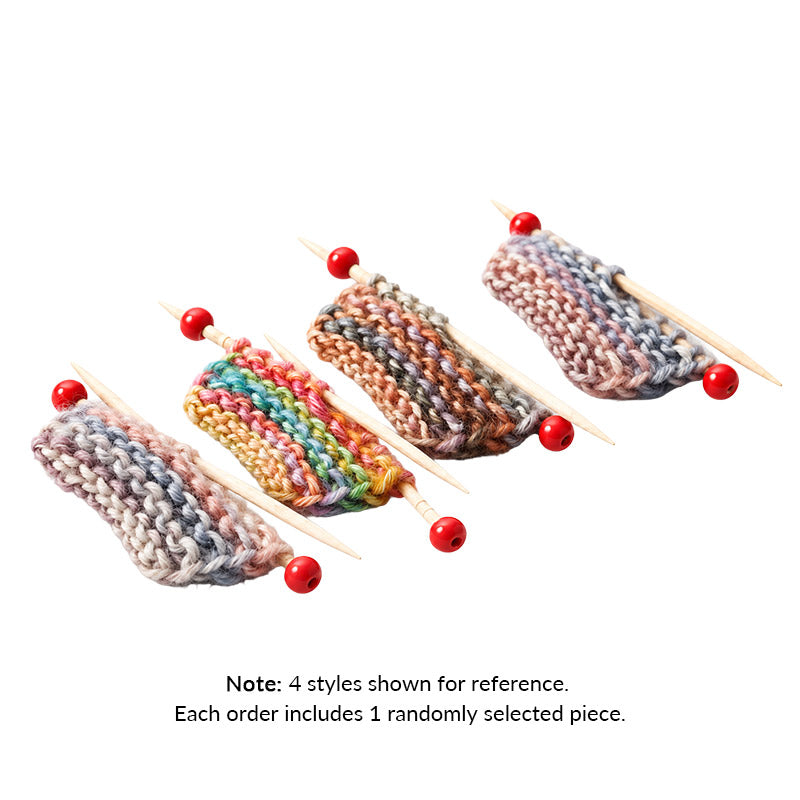 Miniature Knitting Project with colorful gradient yarn and tiny red-tipped needles, adding handmade charm to a cozy dollhouse.